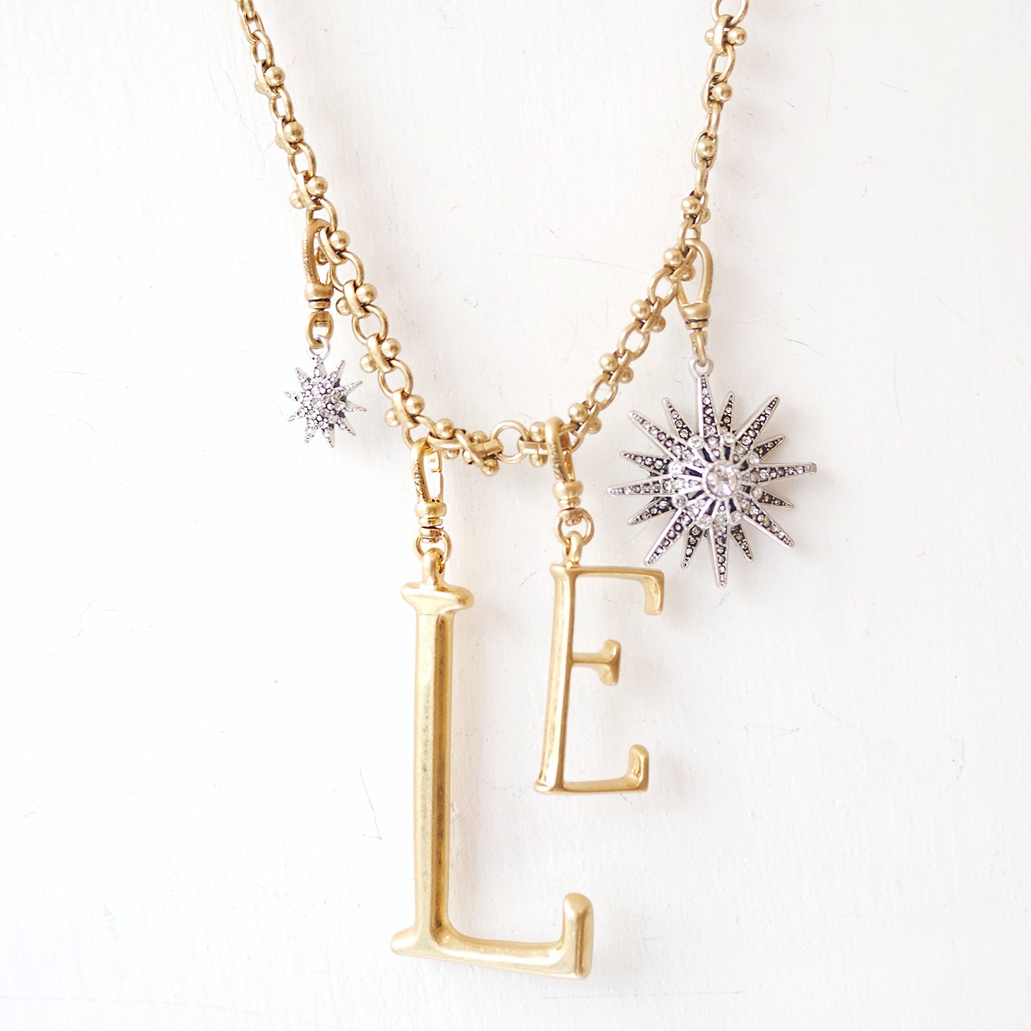 The Lulu Frost radiant charm features an Art Deco-inspired star motif that represents transcendence. Pair with one of the chain bases and add additional charms to create a special piece all your own. 