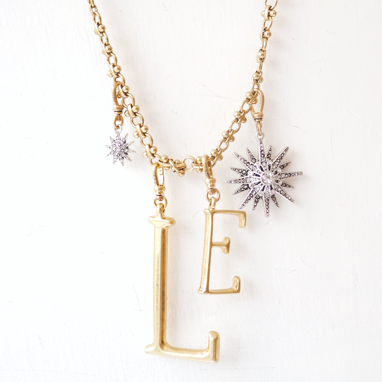 The Lulu Frost radiant charm features an Art Deco-inspired star motif that represents transcendence. Pair with one of the chain bases and add additional charms to create a special piece all your own.
