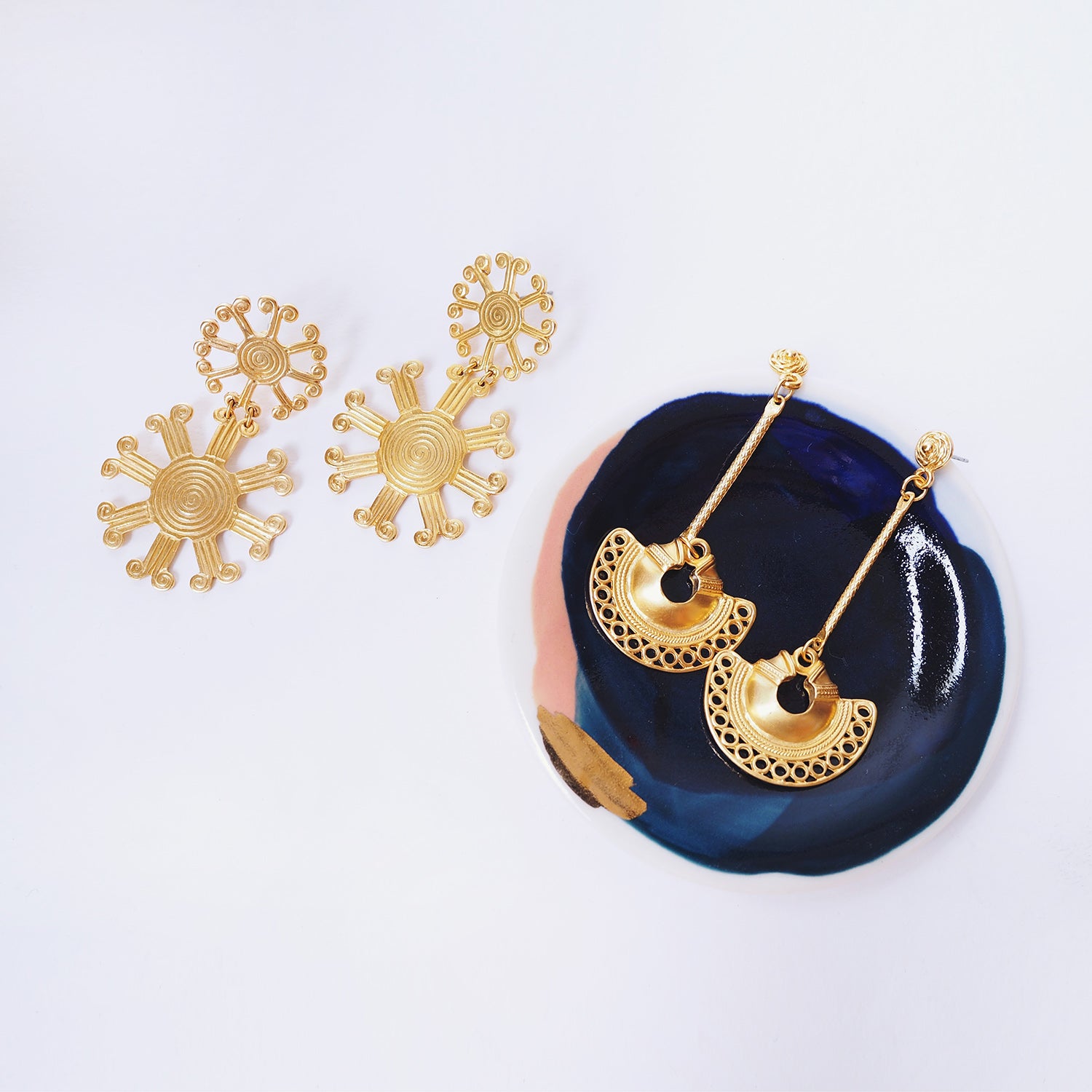 These earrings are a reproduction of pre-colombian jewellery found in the Americas before the Conquistadors arrived. Much of the gold was melted and shipped back to Spain but what little survived can be found in the Museums of Pre-Colombian art in the region. These earrings take on pre-colombian elements and reassemble them into earrings.