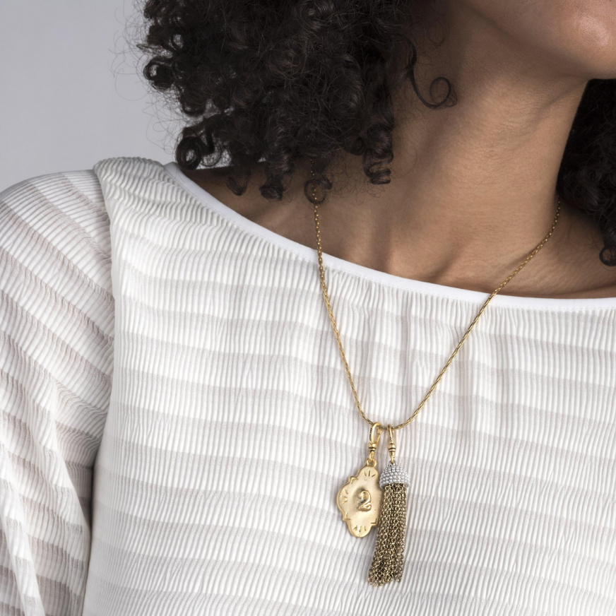 This Lulu Frost charm is inspired by 60's icon Ursula Andress, featuring pearl-encrusted dome tops paired with cascading chain tassels. Pair with one of the chain bases and add additional charms to create a special piece all your own.