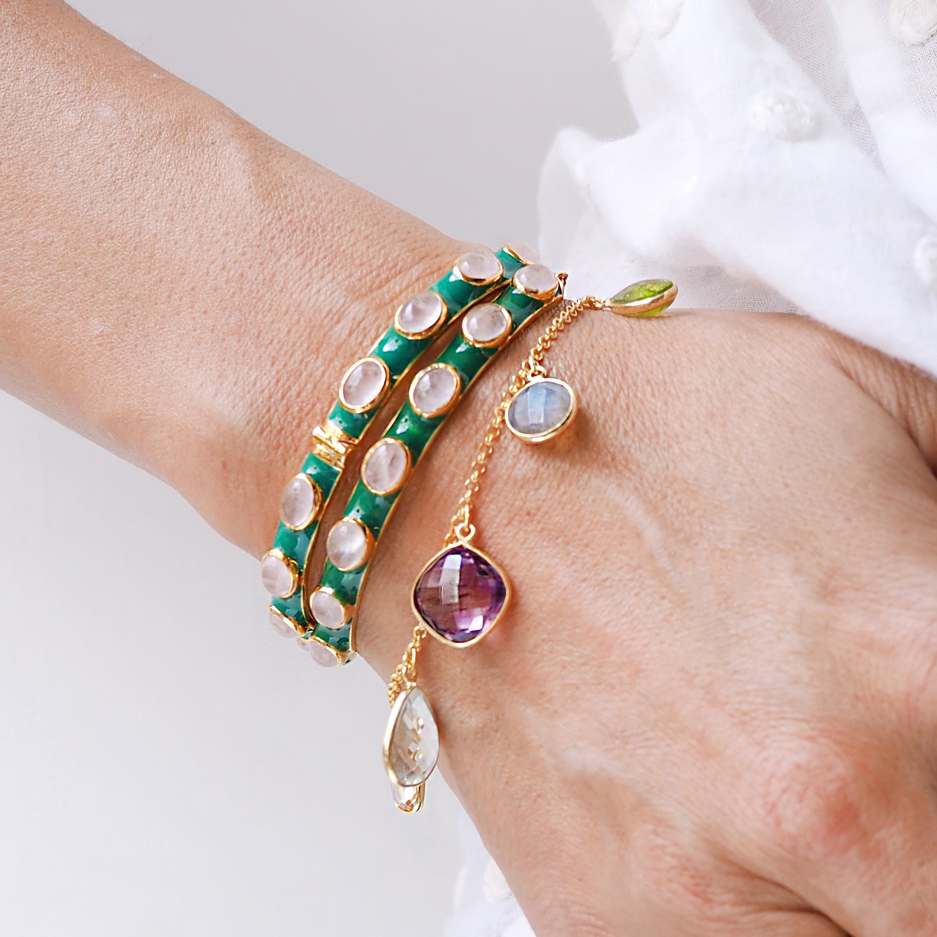 Green enamel and rose quartz stones make this bracelet a standout addition to any stack.  Lovely contrasting colours.   