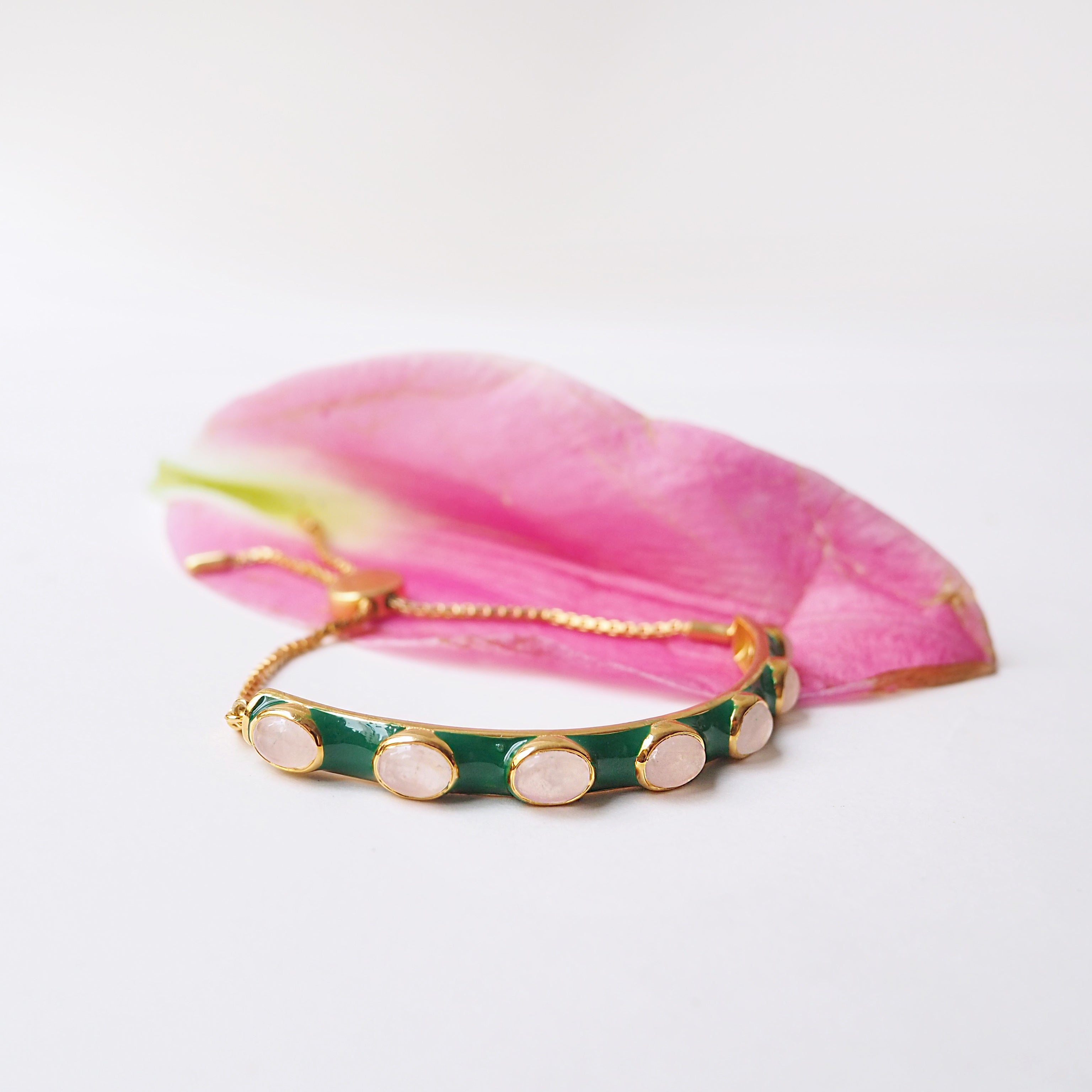 Green enamel and rose quartz stones make this bracelet a standout addition to any stack.  Lovely contrasting colours.   