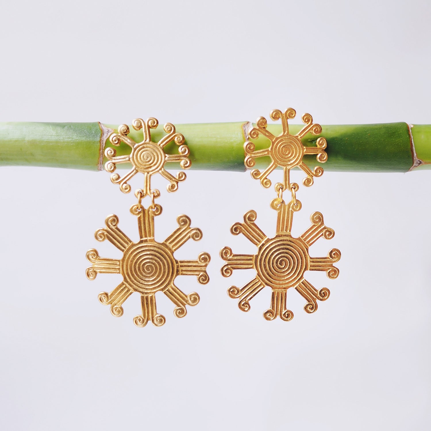These earrings are a reproduction of pre-colombian jewellery found in the Americas before the Conquistadors arrived. Much of the gold was melted and shipped back to Spain but what little survived can be found in the Museums of Pre-Colombian art in the region. These earrings take on pre-colombian elements and reassemble them into earrings.